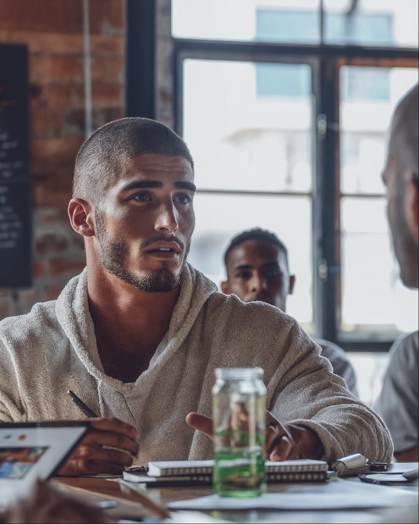 Man focused during a work meeting after using Humn Well Bounce Back Energy Strips for a natural energy boost and mental clarity.
